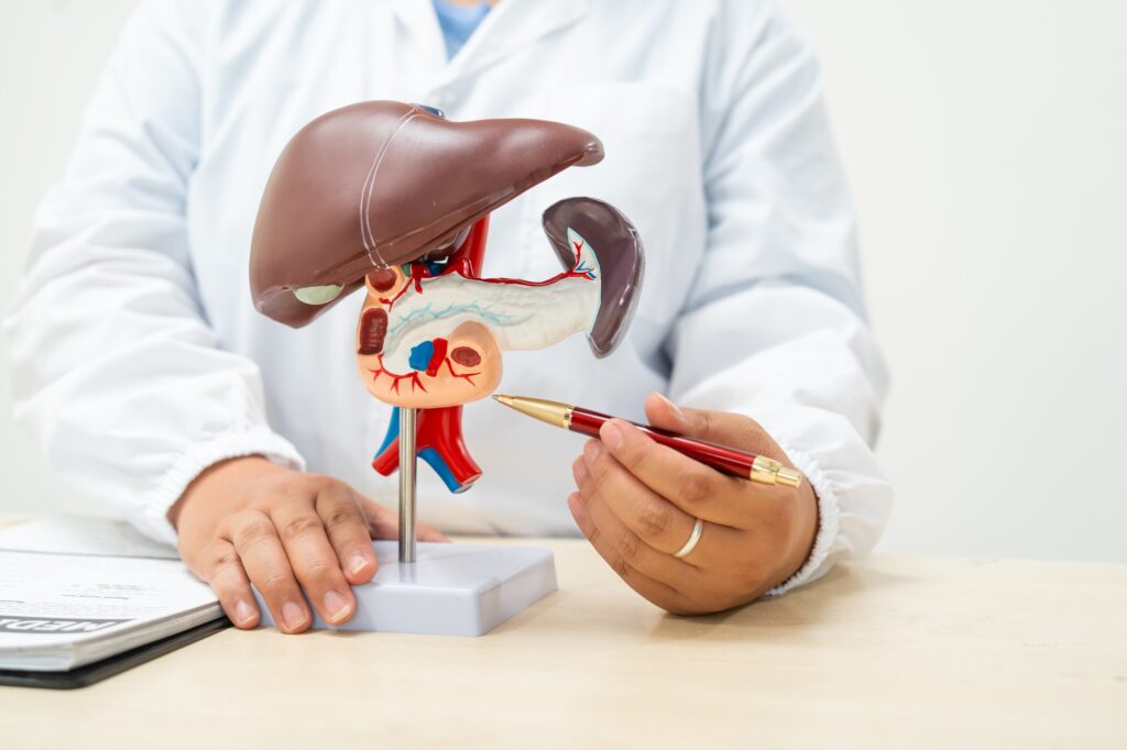 A female doctor works at a desk in hospital, discussing liver diseases like hepatitis B,cirrhosis