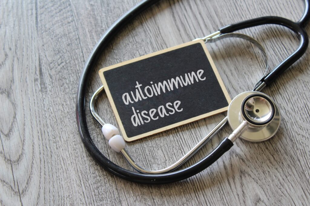 Stethoscope and chalkboard with text AUTOIMMUNE DISEASE